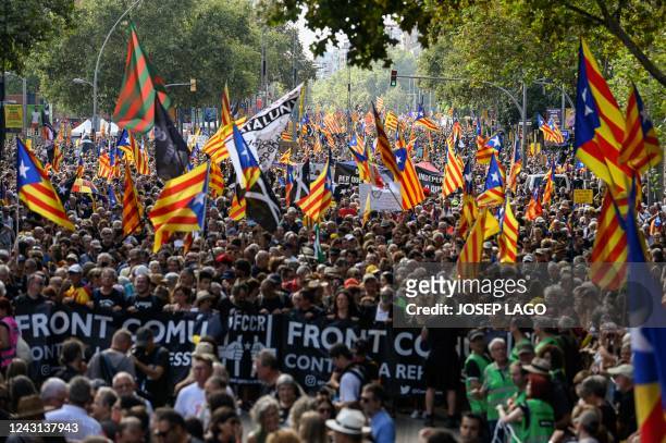 Demonstrators wave Catalan pro-independence "Estelada" flags during a protest marking the "Diada", the national day of Catalonia, in Barcelona on...