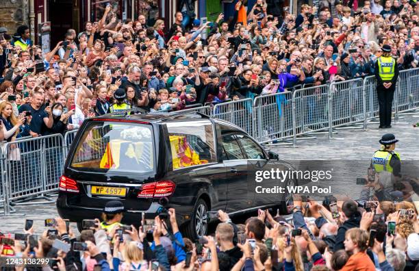 The hearse carrying the coffin of Queen Elizabeth II, draped with the Royal Standard of Scotland, passes down the Royal Mile, Edinburgh, on the...