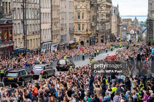 The hearse carrying the coffin of Queen Elizabeth II, draped with the Royal Standard of Scotland, passes down the Royal Mile, Edinburgh, on the...