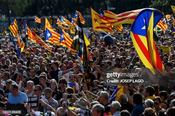 Demonstrators cheer and wave Catalan pro-independence "Estelada" flags during a protest marking the "Diada", the national day of Catalonia, in...