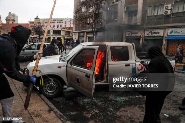 Demonstrators set a vehicle of the municipality on fire during the commemoration of the 49th anniversary of the 1973 military coup d'etat of Augusto...