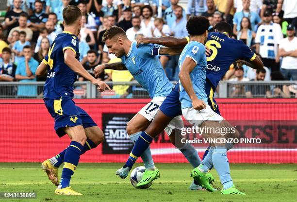 Lazios Italian forward Ciro Immobile fights for the ball with Veronas Swedish defender Isak Hien during the Italian Serie A football match betwen...