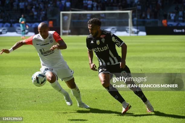 Montpellier's French forward Wahbi Khazri fights for the ball with Angers' Moroccan forward Sofiane Boufal during the French L1 football match...