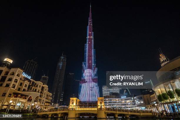 Portrait of Queen Elizabeth II of the United Kingdom superimposed with the British Union Jack national flag is projected upon the Burj Khalifa, the...