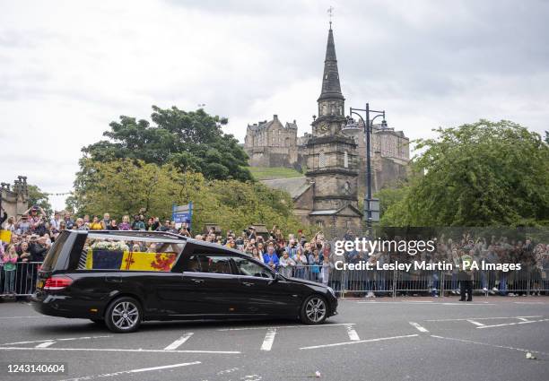 The hearse carrying the coffin of Queen Elizabeth II, draped with the Royal Standard of Scotland, passing Edinburgh Castle as it continues its...