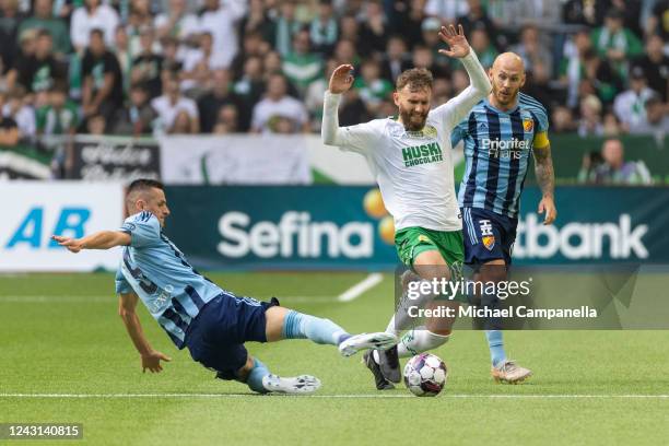 Haris Radetinac of Djurgarden tackles Simon Sandberg of Hammarby during an Allsvenskan match between Hammarby IF and Djurgardens IF at Tele2 Arena on...