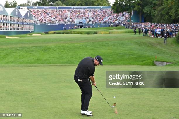 Ireland's Shane Lowry plays his approach shot from the 18th fairway on the final day of the BMW PGA Championship at Wentworth Golf Club, south-west...
