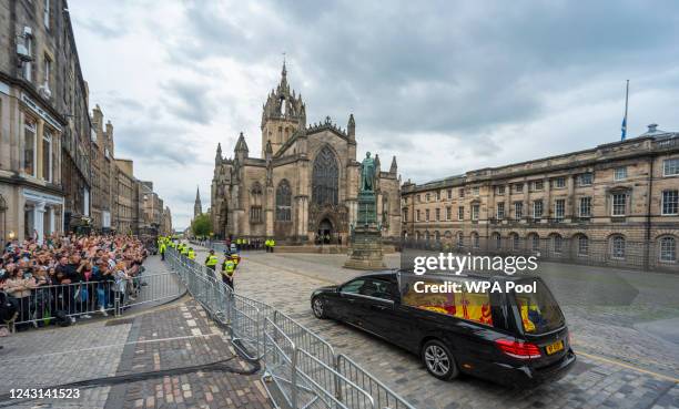 The hearse carrying the coffin of Queen Elizabeth II passes St Giles' Cathedral in Edinburgh on its way to the Palace of Holyroodhouse as it...