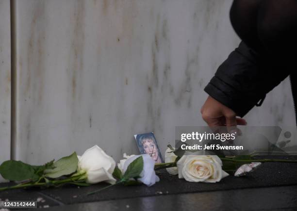 Photo of Deborah Jacobs Walsh with flowers at her stone at the Wall of Names at the Flight 93 National Memorial during a ceremony commemorating the...