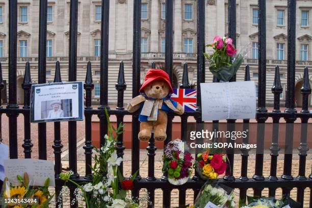 Paddington Bear toy is seen alongside flowers and tributes outside Buckingham Palace as thousands of people continue to arrive to pay their respects...