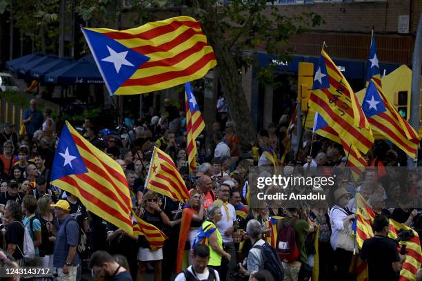 Demonstrators wave Catalan pro-independence "Estelada" flags during a protest marking the "Diada", the national day of Catalonia, in Barcelona on...