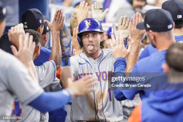 Jeff McNeil of the New York Mets celebrates with teammates after scoring during the second inning against the Miami Marlins at loanDepot park on...