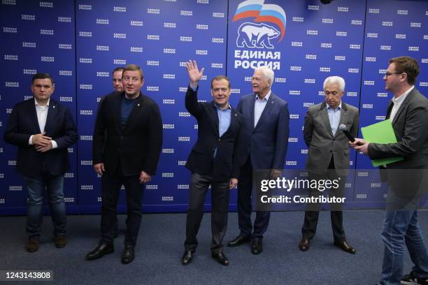 Russian Security Council Deputy Chairman and leader of the United Russia Party Dmitry Medvedev smiles as Poitical Council of the Party Andrei Turchak...