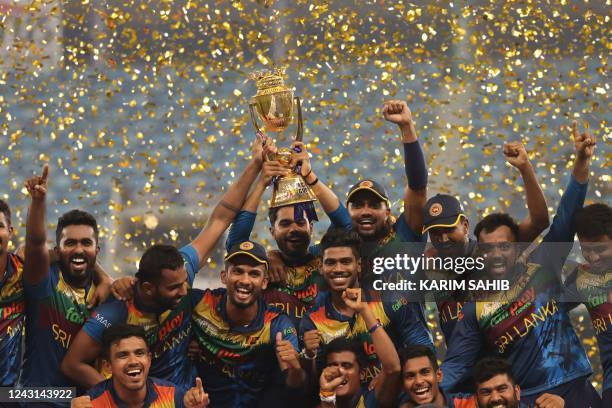 Sri Lanka's players celebrate with the trophy at the end of the Asia Cup Twenty20 international cricket final match between Pakistan and Sri Lanka at...