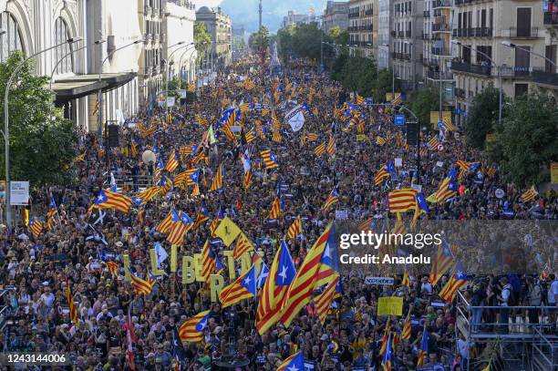 Demonstrators wave Catalan pro-independence "Estelada" flags during a protest marking the "Diada", the national day of Catalonia, in Barcelona on...