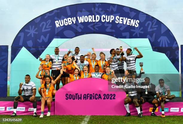 Sevens winners, Australia women and Fiji men celebrate on the podium during day 3 of the Rugby World Cup Sevens 2022 at DHL Stadium on September 11,...