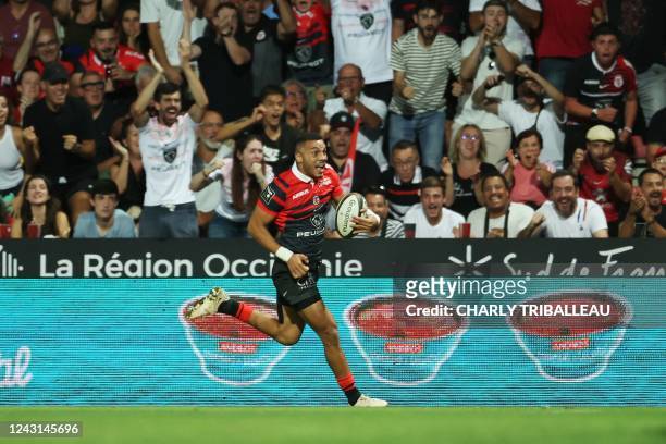 Toulouse's French full back Matthis Lebel runs to score a try during the French Top14 rugby union match between Stade Toulousain Rugby and RC...