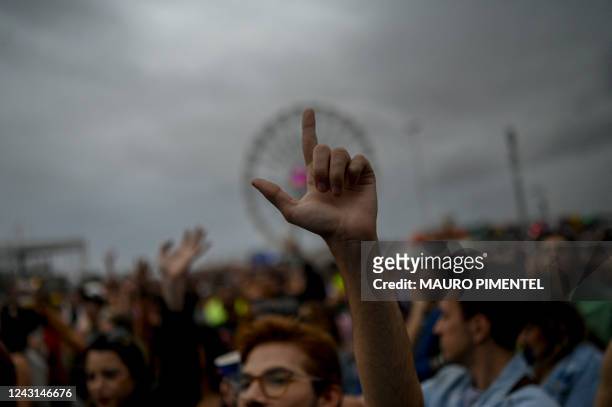 Fan flashes the L symbol, in support of Brazilian presidential candidate for the leftist Workers Party and former president Luiz Inacio Lula, during...