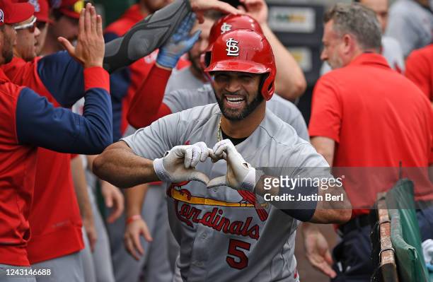 Albert Pujols of the St. Louis Cardinals reacts in the dugout after hitting a two run-home run in the ninth inning during the game against the...