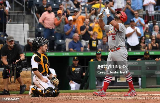 Albert Pujols of the St. Louis Cardinals reacts as he crosses home plate after hitting a two-run home run in the ninth inning during the game against...