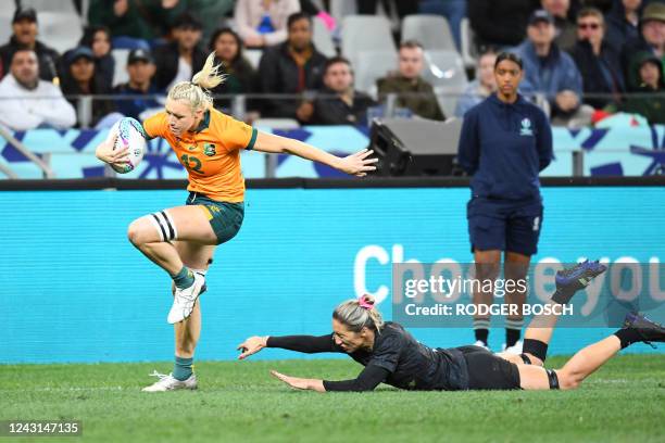 Sarah Hirini of New Zealand tries to stop Maddison Levi of Australia during the women's rugby sevens championship final match between Australia and...