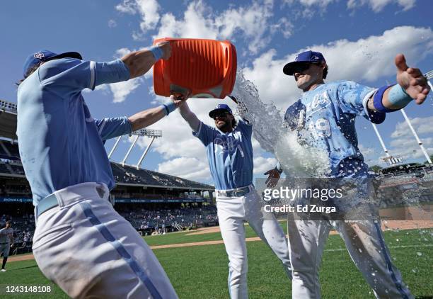 Michael Massey of the Kansas City Royals is doused with water by Bobby Witt Jr. #7 and MJ Melendez as they celebrate a 4-0 win over the Detroit...