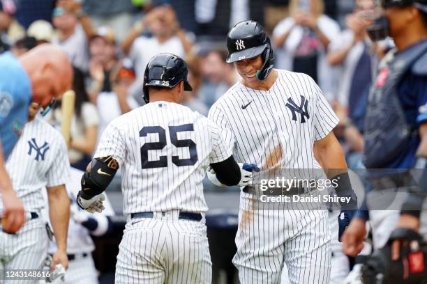 Gleyber Torres of the New York Yankees celebrates with Aaron Judge after hitting a three-run home run in the first inning during the game between the...