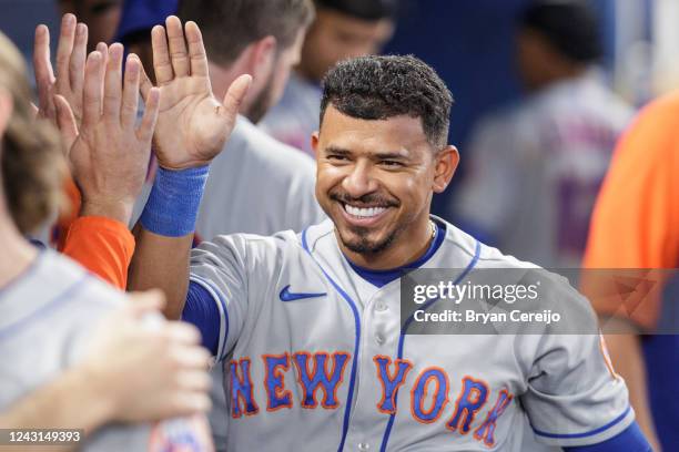 Eduardo Escobar of the New York Mets celebrates with teammates after scoring a run during the fifth inning against the Miami Marlins at loanDepot...