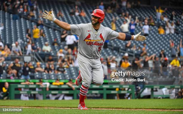 Albert Pujols of the St. Louis Cardinals reacts as he runs the bases after hitting a two-run home run in the ninth inning during the game against the...