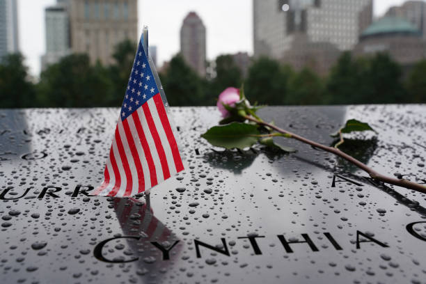 Families of the victims of the September 11 attacks circle the North Tower pool at the 9/11 Memorial & Museum in New York City, United States on the...