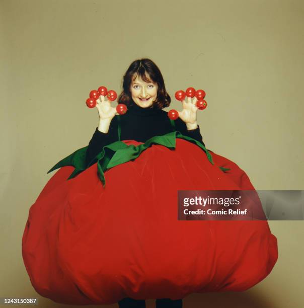 Janine Duvitski inside a giant tomato and showing off the range of noses for Red Nose Day in 1993 in England.