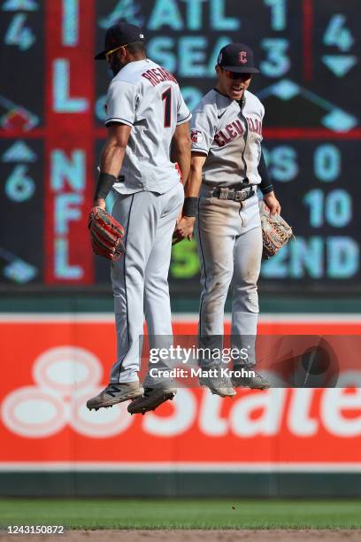 Amed Rosario and Steven Kwan of the Cleveland Guardians celebrate a 4-1 victory against the Minnesota Twins at Target Field on September 11, 2022 in...