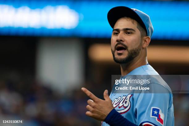 Pitcher Martin Perez of the Texas Rangers talks with a teammate after getting out of the fifth inning against the Toronto Blue Jays at Globe Life...