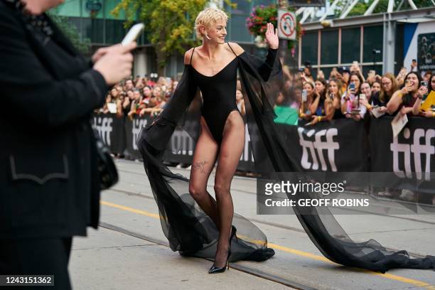 Emma Corrin waves as she arrives at the red carpet for the premiere of My Policeman at the Toronto International Film Festival in Toronto, Ontario,...