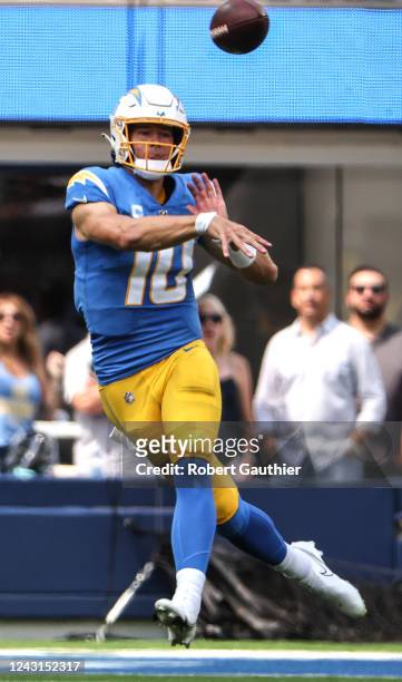 Inglewood, CA, Sunday, September 11, 2022 - Los Angeles Chargers quarterback Justin Herbert leaps as he throws a complete pass to Los Angeles...