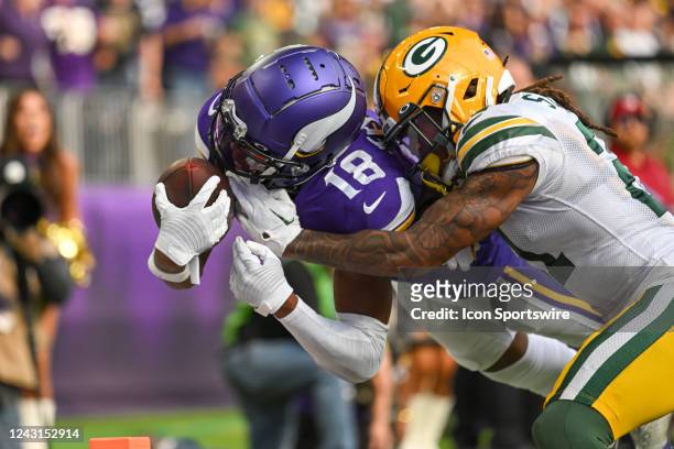 Minnesota Vikings wide receiver Justin Jefferson dives into the end zone with Green Bay Packers cornerback Eric Stokes on his back for a 36-yard...