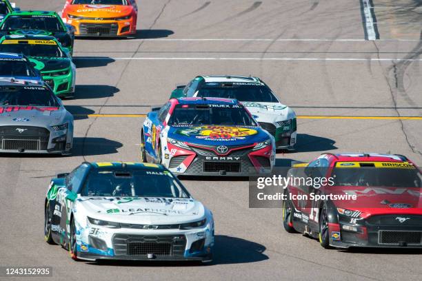 Race cars leave pit road during the NASCAR Cup Series Hollywood Casino 400 on September 11 at the Kansas Speedway in Kansas City, Kansas.