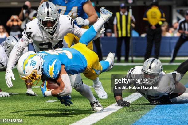 Inglewood, CA, Sunday, September 11, 2022 - Los Angeles Chargers running back Austin Ekeler is tripped at the goal line by Las Vegas Raiders...