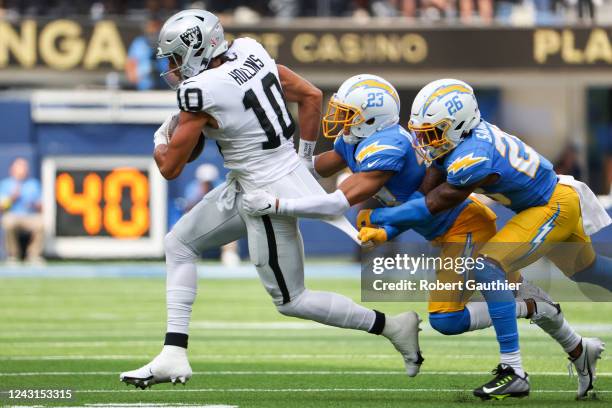 Inglewood, CA, Sunday, September 11, 2022 - Las Vegas Raiders wide receiver Mack Hollins tries to shake the tackles of Los Angeles Chargers...