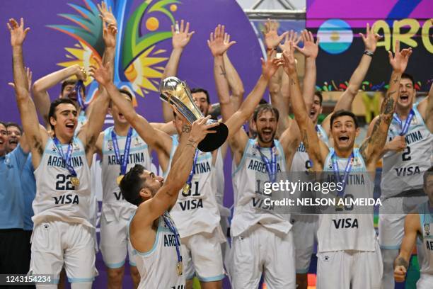 Argentina basketball team captain Facundo Campazzo holds the championship trophy after winning the FIBA Men's AmeriCup basketball final game against...