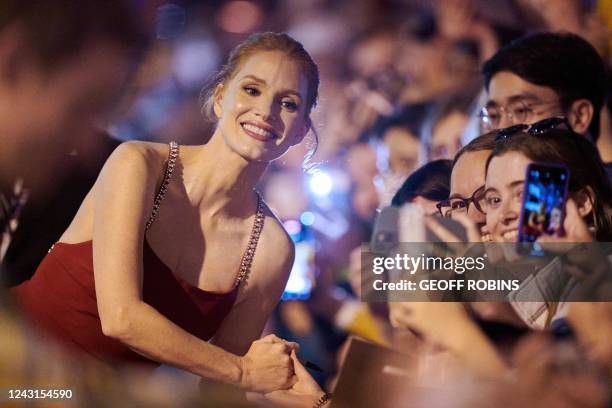 Actress Jessica Chastain poses for a pictures with fans as she arrives for the premiere of The Good Nurse during the Toronto International Film...