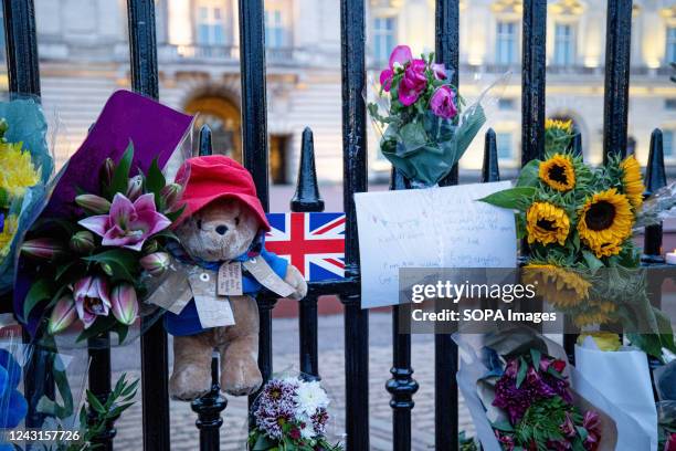 Paddington bear with messages and flowers is hanging at the gate of Buckingham Palace. Crowds of mourners and well wishers from all over the world...