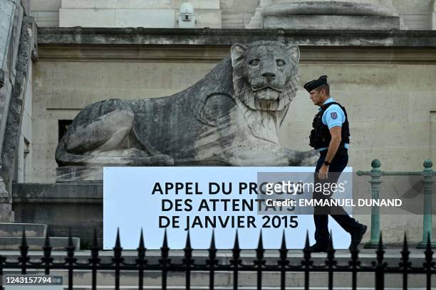 French gendarme walks outside the Palais de Justice ahead of the appeal trial of the Charlie Hebdo attacks when members of the French satirical...