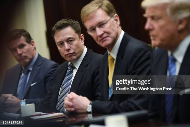 Kevin Plank of Under Armour, left to center, Elon Musk of SpaceX and Wendell P. Weeks of Corning listen to President Donald Trump during a meeting...