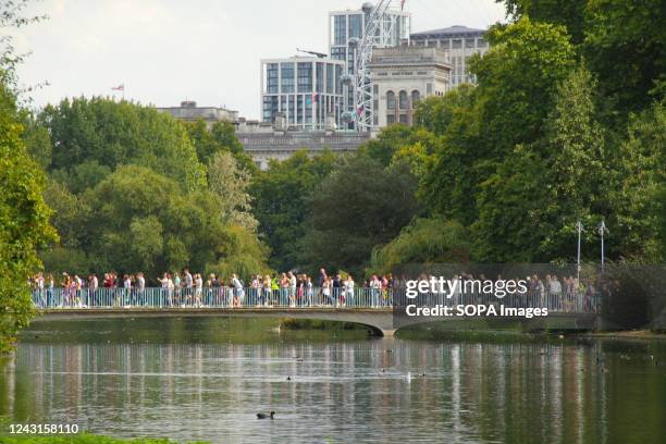 People seen walking across The Blue Bridge at St James's Park attempting to get to The Mall as crowds gathered around the Palace. Queen Elizabeth II...