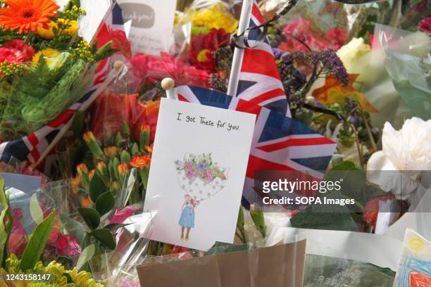 People seen around floral tributes by a tree at St James Park. Queen Elizabeth II was queen for 70 years and 214 days was the longest of any British...