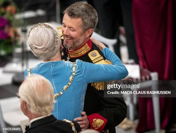 Danish Queen Margrethe gives her son Crown Prince Frederik a hug after his speech at the gala banquet at Christiansborg Palace on September 11 during...