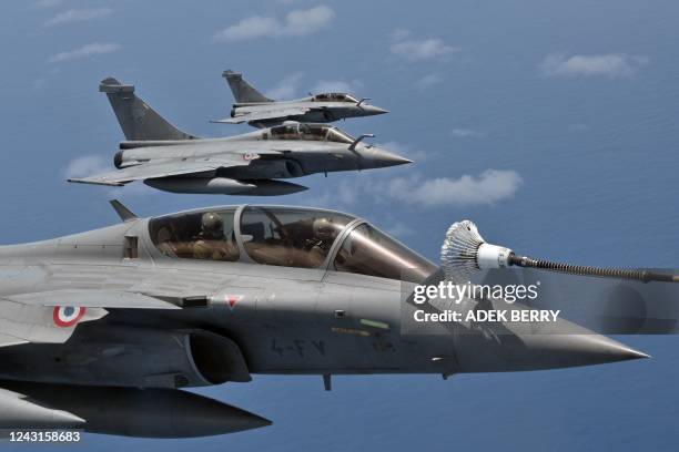 Dassault Rafale multirole combat aircraft refuels from a drogue of an Airbus A330 MRTT Phenix tanker-transport aircraft during a demonstration flight...