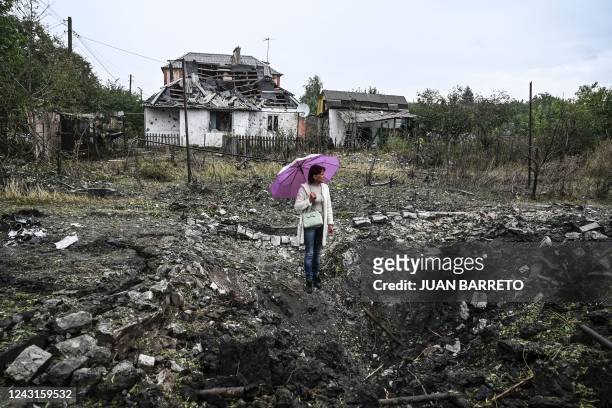 Woman stands in front of a destroyed house, in Kramatorsk, Donetsk region, on September 12 amid the Russian invasion of Ukraine.