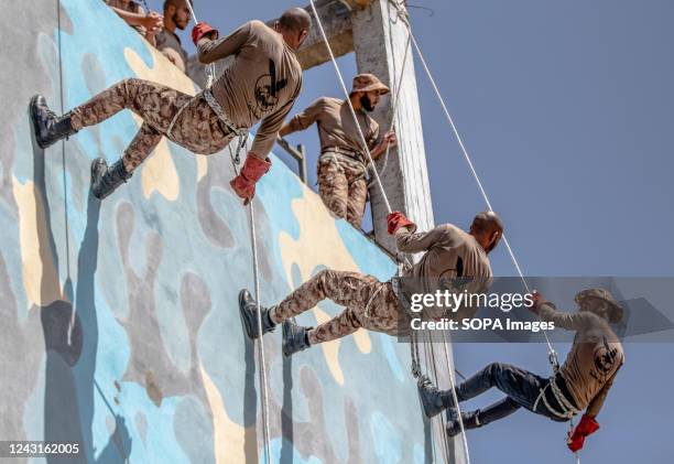 Palestinian students from the Palestinian security forces affiliated with Hamas, display their military capabilities at the Rabat University College...